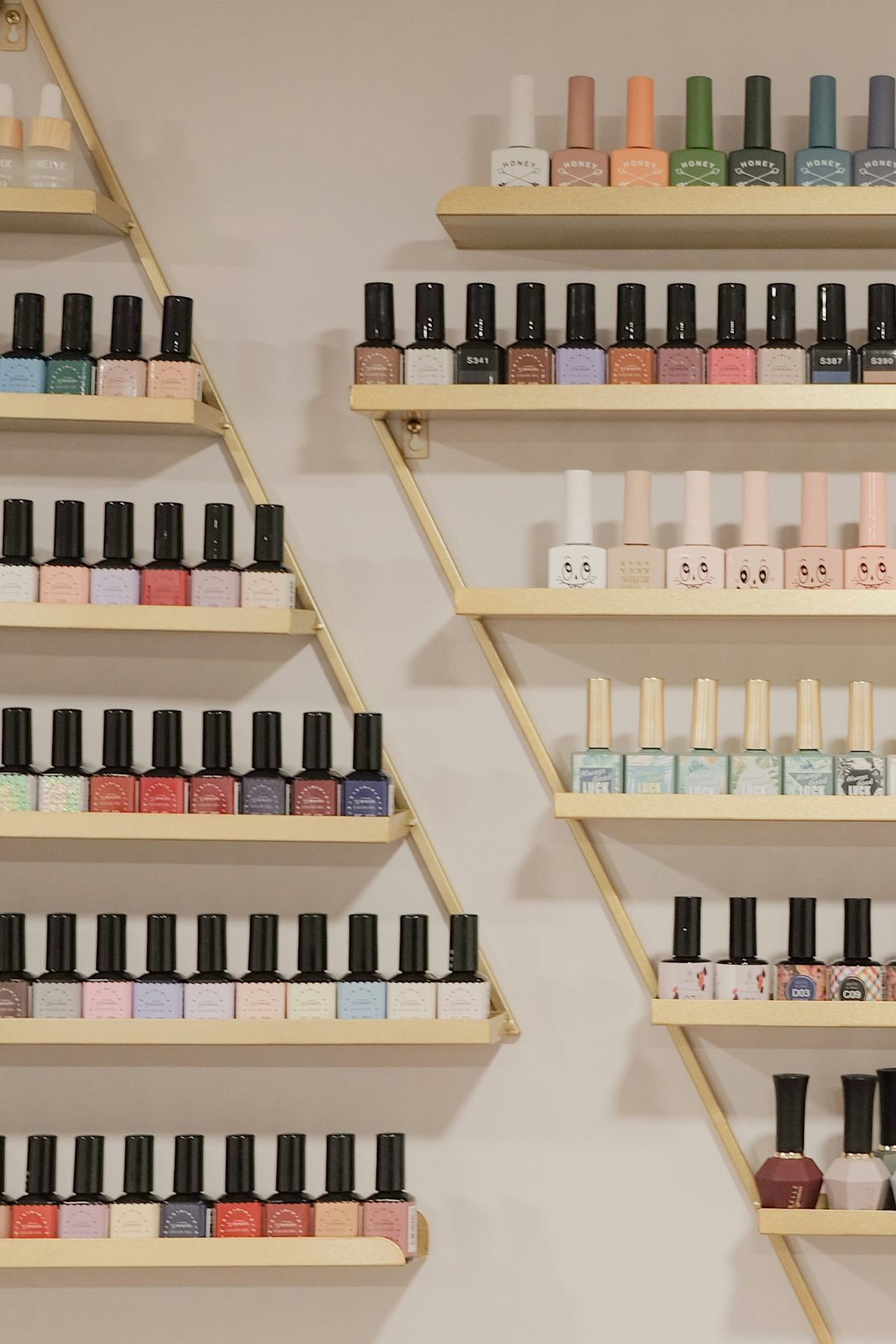 Rows of nail polish on wall shelves